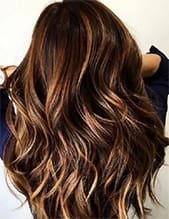 a person with long hair with balayage highlights