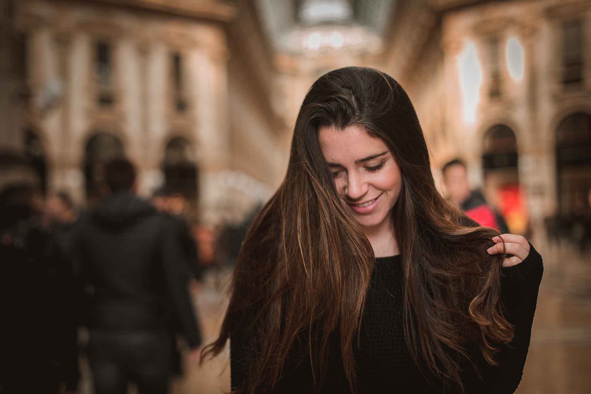 A woman with long hair is smiling for the camera.